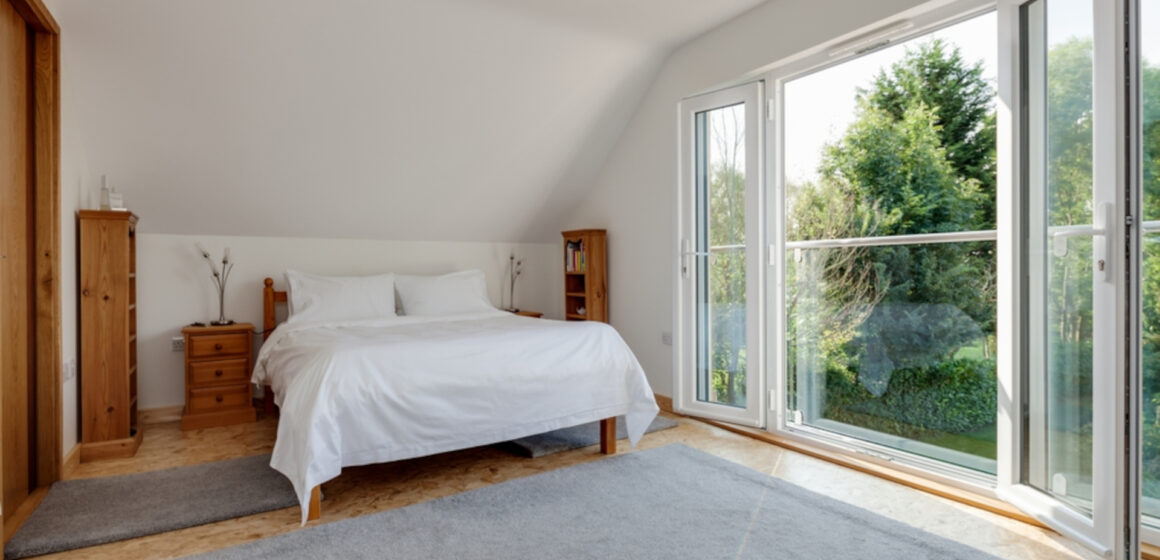 Furnished bright sunlit bedroom with pine furniture and open upvc double glazed doors to juliet balcony